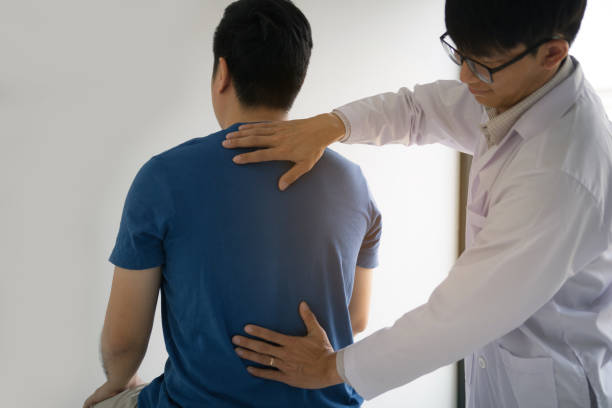 istock Physical therapists are using hands to check the back of the patient. 1161544393