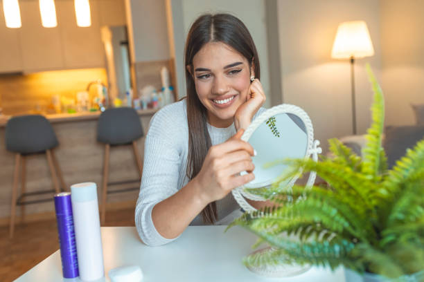 istock Beautiful young woman looking at self in mirror. 1161546028