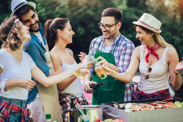 istock Young friends having fun grilling meat enjoying barbecue party. 1161546583