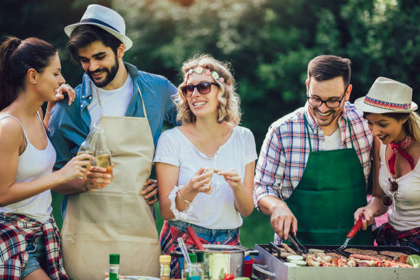 istock Young friends having fun grilling meat enjoying barbecue party. 1161546659