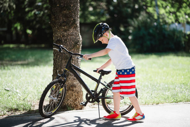 istock Little boy repairing a bicycle 1161548440