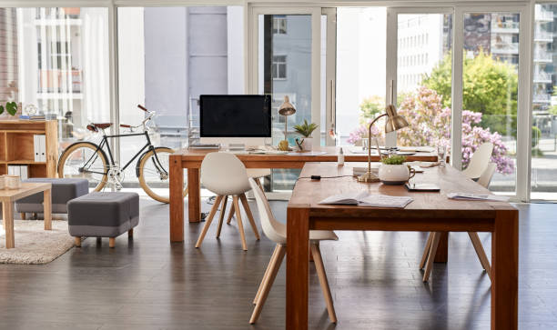 Still life shot of an empty modern office furnished with tables and chairs