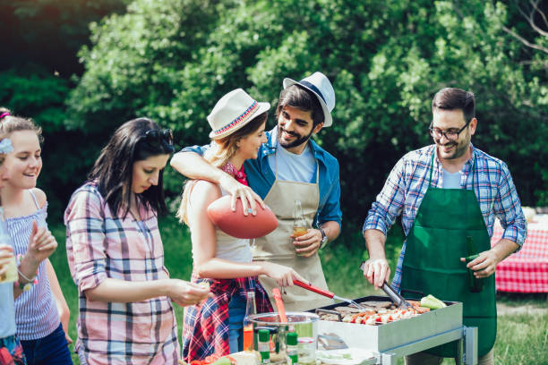 istock Young friends having fun grilling meat enjoying barbecue party. 1161551116