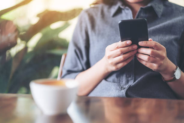 istock a woman holding  and using mobile phone 1161552296
