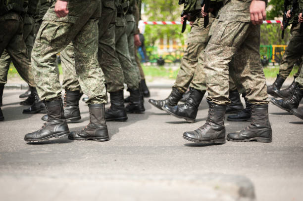 Marching soldiers in military boots stock photo