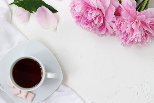istock morning mood, cup of coffe and flowers on white textured table 1161555003