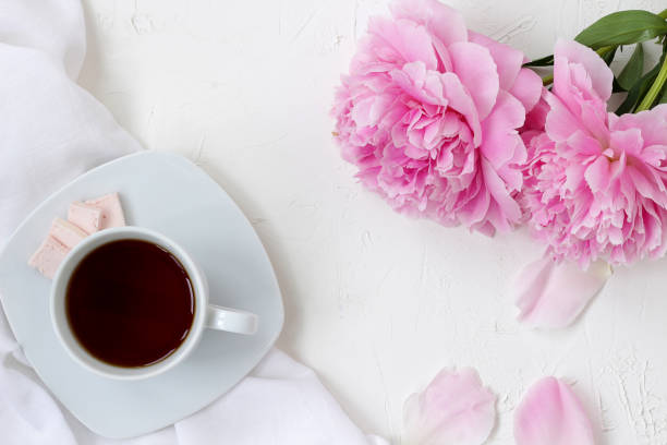istock morning mood, cup of coffe and flowers on white textured table 1161555034