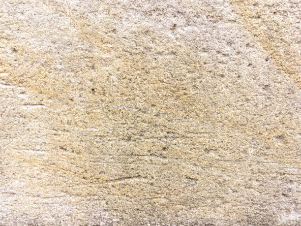 istock Old beige cracked limestone wall, close up. 1161555497