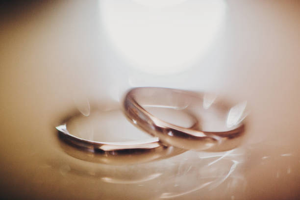 Wedding rings on shiny background.