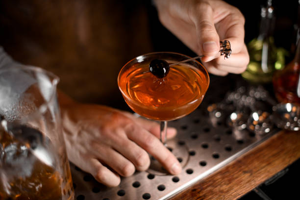 istock Professional bartender putting berry on the skewer on the cocktail glass 1161558233