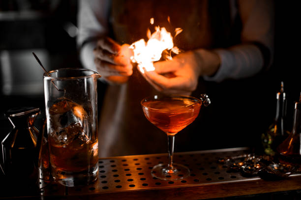 istock Bartender putting fire from the lighter on the cocktail glass 1161558240