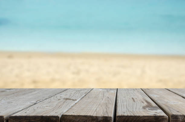 istock wood table top sea and beach 1161558306