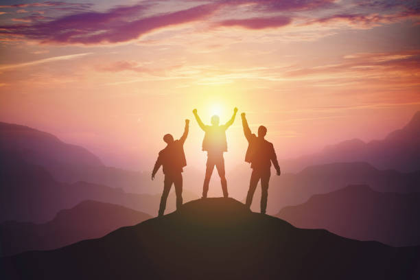 istock Silhouette of the team on the mountain 1161558328
