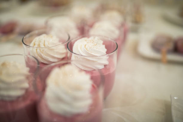 Strawberry mouse with whipped cream in glass served on table at wedding celebration