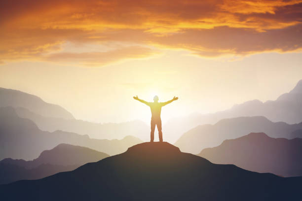 istock Climber arms up outstretched on mountain top looking at inspirational landscape. 1161560096