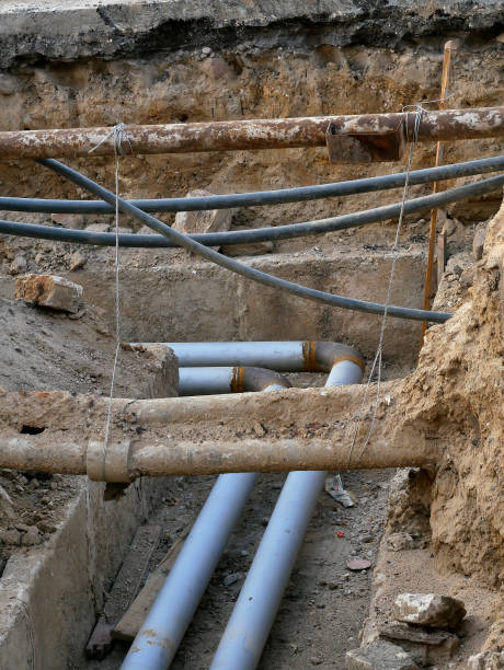 istock underground utilities, excavated pipes in the ground 1161562774