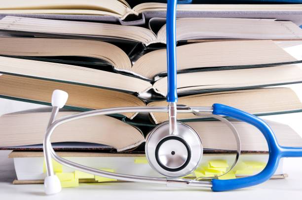 istock Open medical books, stethascope. Process of medical learning 1161564962