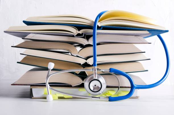 medical knowledge. pile of open books for medical student - medical exam fotos imagens e fotografias de stock