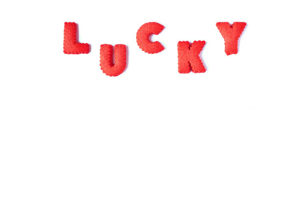istock The word LUCKY spelled with red colored alphabet shaped biscuits on white background 1161566772