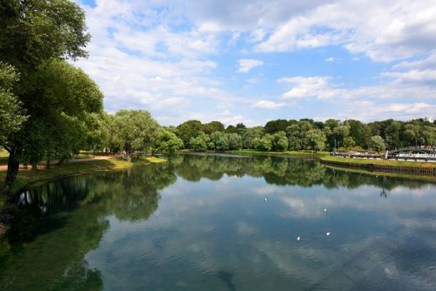 istock Trees and blue sky are reflected on the lake 1161569766