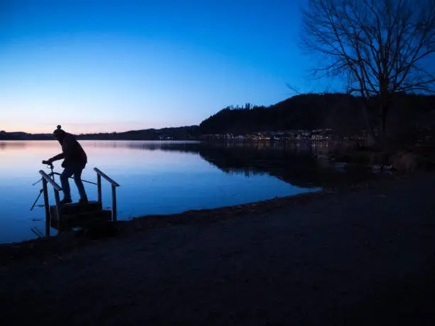 Photo of Angler silhouette at the Lake Hopfen