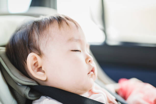 baby sleeping on child safety seat in a car - car baby baby car seat child imagens e fotografias de stock