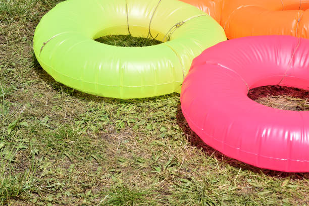 istock water circles for water slides. inflatable wheels for high-speed descent from the slides on the green grass 1161575169
