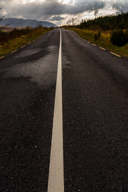 istock Solid white line down the middle of a rural road in County Donegal, Ireland 1161575894