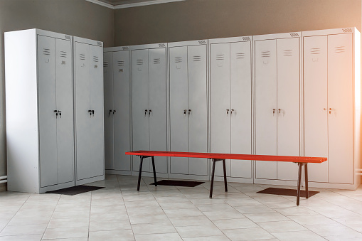 locker room in the gym  with metal drawers and benches