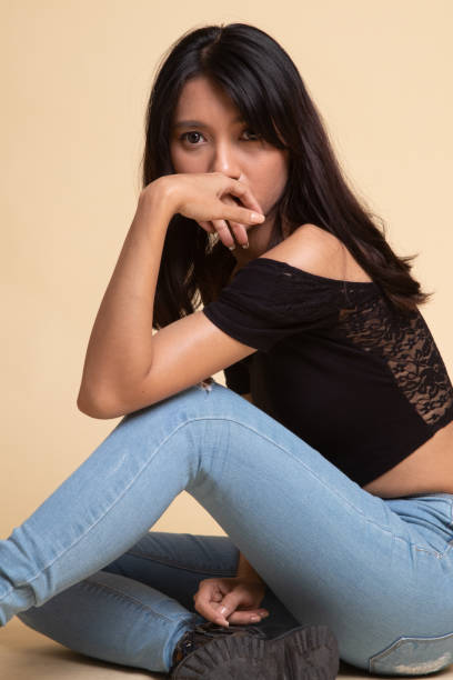 istock Beautiful young asian woman sit on floor 1161576371