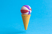 istock Basketball ball in ice cream cone abstract isolated on blue. 1161578975