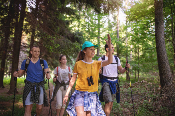 istock Lovely girl leading her friends while hiking 1161580526