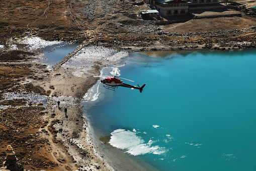 The helicopter over Amazing Gokyo lake in mountains, Trekking in Everest region, Nepal