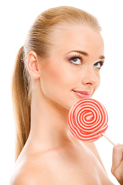 Candy girl Portrait of blonde holding big lollipop. eye candy stock pictures, royalty-free photos & images