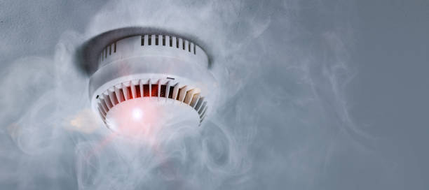 Smoke detector in apartment Smoke detector mounted on roof in apartment smoke detector photos stock pictures, royalty-free photos & images