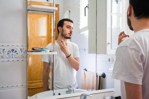 istock Man looking at himself in a mirror in the bathroom. He is casting colony 1161582501