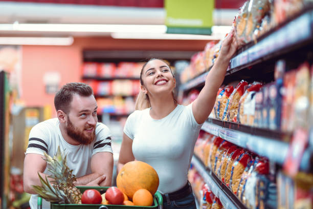 istock Smiling Couple Looking At Different Products In Supermarket 1161583900