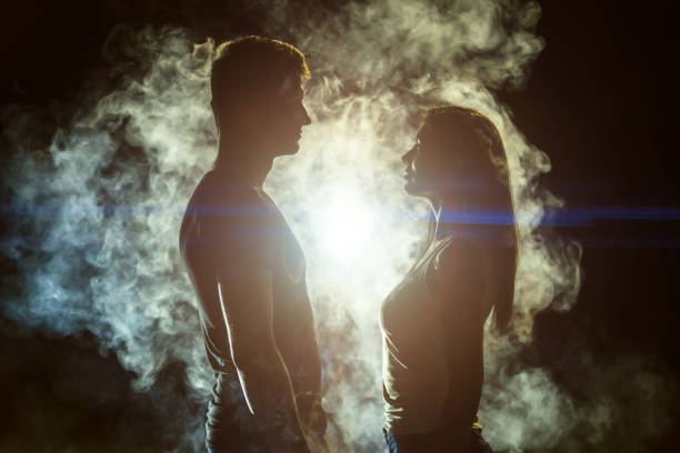 istock The couple standing in the smoke on a bright light background 1161583926