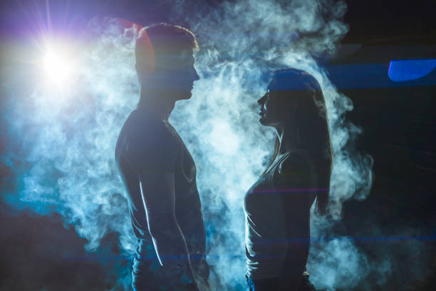 istock The couple standing in the smoke on a bright light background 1161583932