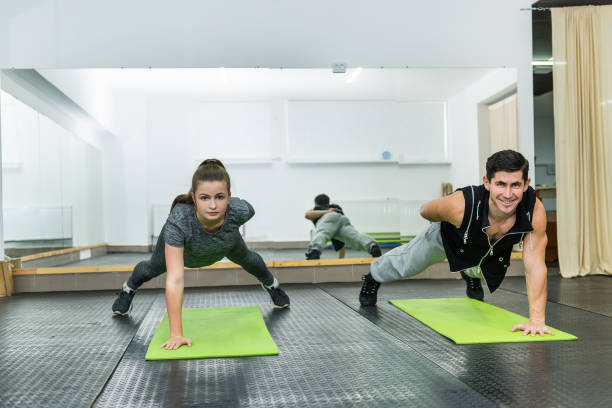 istock Two people in gym doing plank exercise together 1161584053