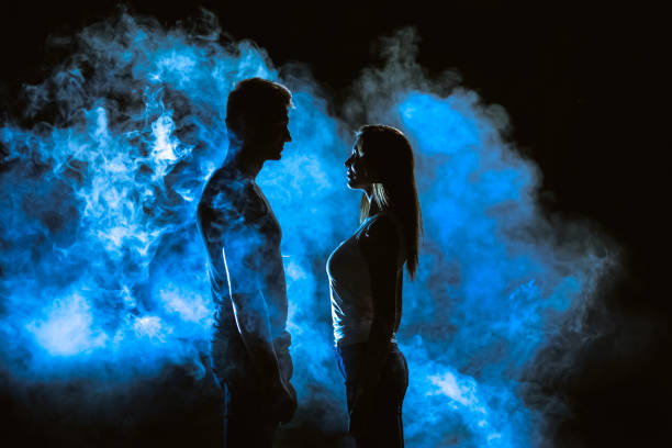 istock The couple standing in smoke on the dark background 1161584140