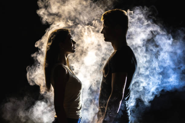 istock The couple standing in smoke on the dark background 1161585184