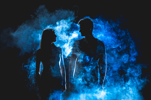 The silhouette of couple in the smoke