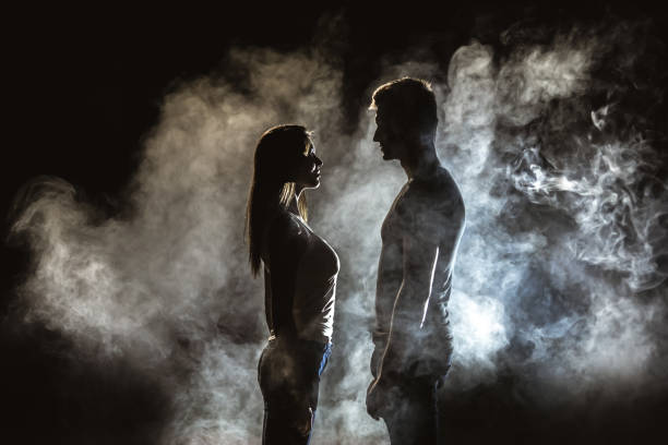 istock The couple standing in smoke on the dark background 1161585229