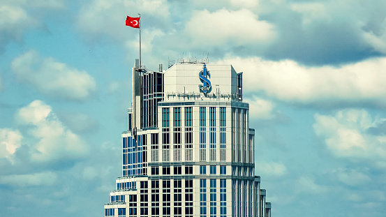 Istanbul Turkey - September 2018: Top floors of Isbank headquarters tower with Turkish flag in Levent