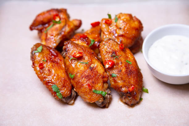 istock Chicken barbecue wings with sauce on paper. 1161588054