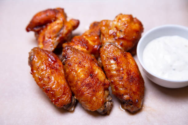 istock Chicken barbecue wings with sauce on paper. 1161588082