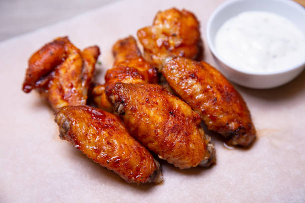 istock Chicken barbecue wings with sauce on paper. 1161588092