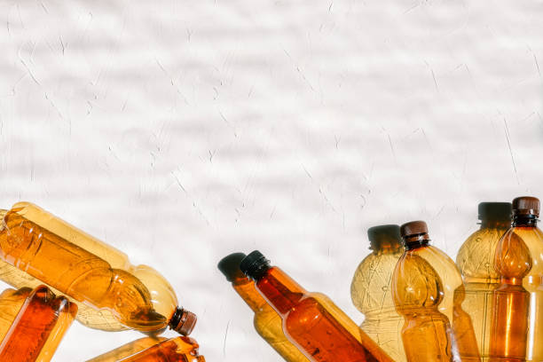 istock Plastic bottles on a white background with a texture. Natural lighting from the sun. Recycling and disposal of waste, environmental problems, environmental protection. Copy space 1161589523