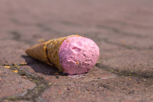 istock Pink ice cream falling to the ground melts in the sun 1161590296
